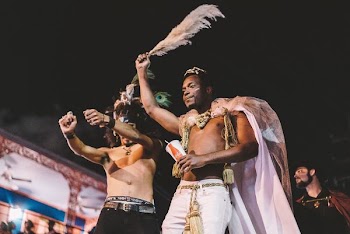 two topless men performing