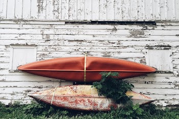 Two used kayaks leaning on an | Free Photo - rawpixel