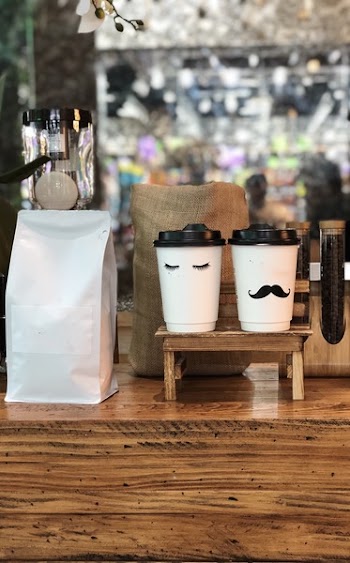 Two White-and-black Plastic Cups on Table
