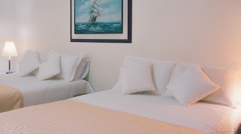Two White Bed Mattresses Near Wall