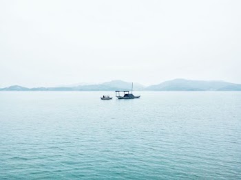 two white boats in middle of sea during daytime