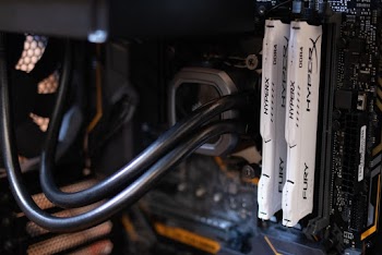Two White Hyper X Fury Computer Dimms on Black Motherboard