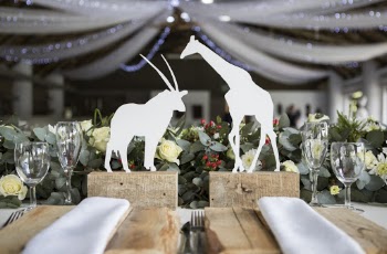 Two White Napkins Across White Silhouette of Animals