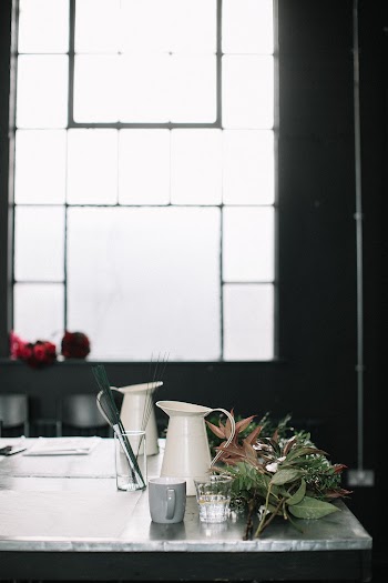 Two White Pitchers and a Gray Mug on Top of a Table
