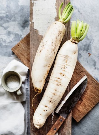 two white radish vegetable and knife