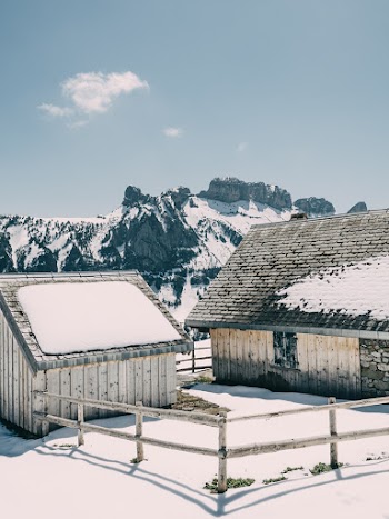 Two White Wooden Houses Near Snow Mountain