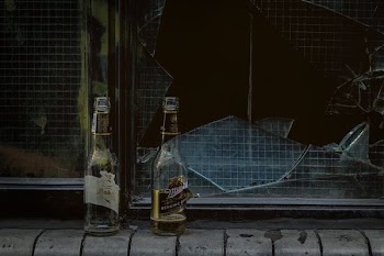 two wine bottles near door