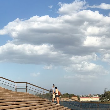 Two Woman and Man Standing in Stair Beside Rail