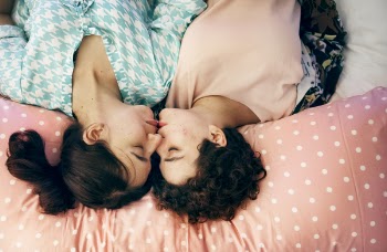Two Woman Kissing on Bed