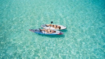 two woman on surfboard floating on water