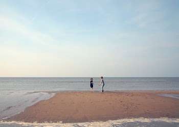 two woman playing in shoreline