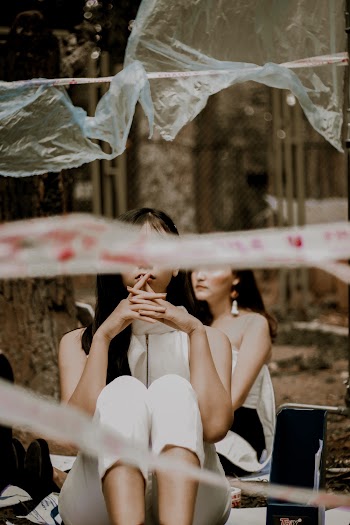 Two Woman Siting on Focus Photography