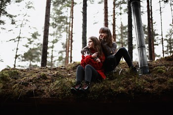 Two Woman Sitting on Brown and Green Grass Outdoors