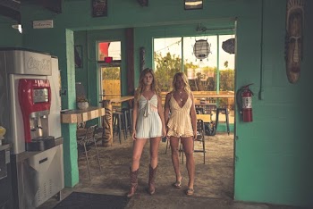 Two Woman Standing Near Fire Extinguisher