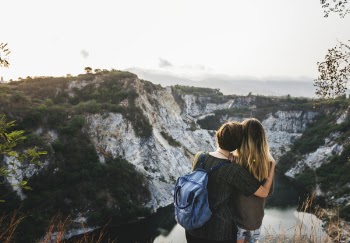 Two Woman Standing on the Ground and Staring at the Mountain