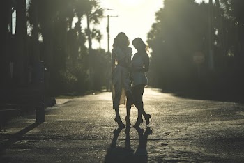 Two Woman Standing on the Middle of the Street