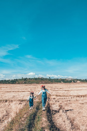 Two Women and Girl Walking on Field