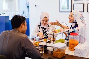 Two Women And One Man Eating
