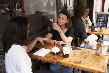 Two Women Having a Meeting in a Cafe