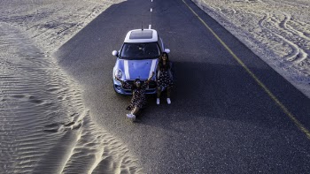 Two Women in Front of Blue Vehicle
