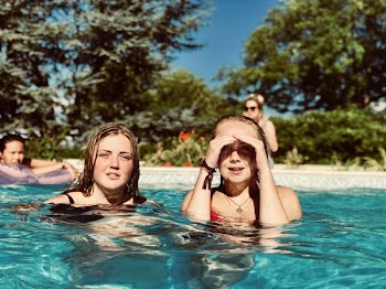Two Women in Swimming Pool Near Trees