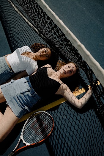 Two Women Lying Beside Net