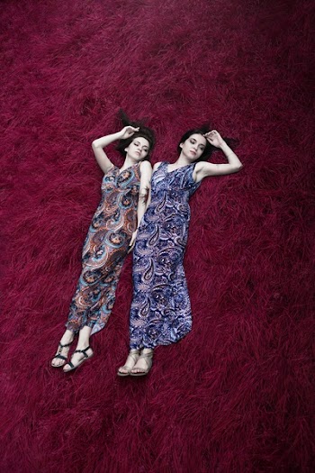 Two Women Lying on Red Surface