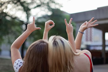 Two Women Making Love Hand Signs