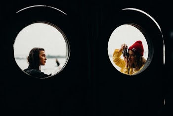 Two Women Near Windowpane