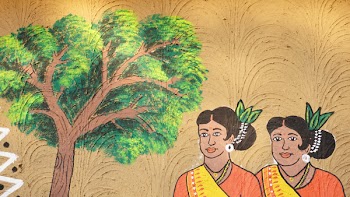 Two Women Next to Tree Painting