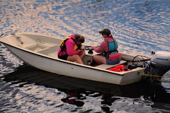 Two Women on Speedboat Sailing on Body of Water