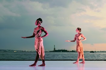 Two Women Posing Near Body of Water