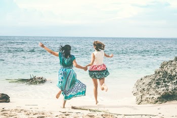 Two Women Running At The Beach