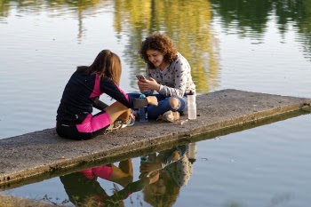 Two Women Sitting on Dockside