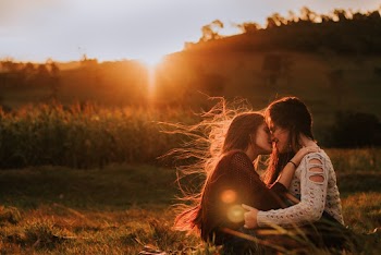 Two Women Sitting On Grass