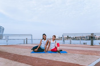 Two Women Sitting on Yoga Mat