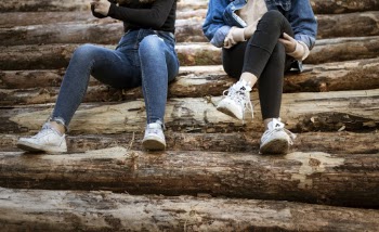 Two Women Sitting Side by Side