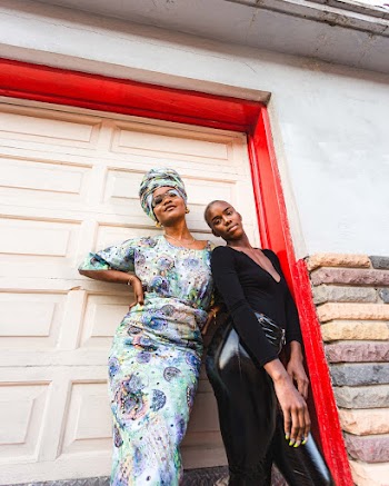 Two Women Standing Beside Garage Door