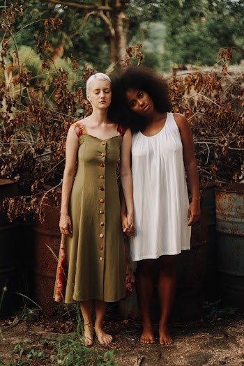 Two Women Standing Near Brown Dry Leaves