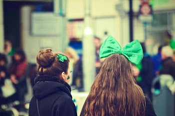 Two Women Standing Near People in Room Selective Focus Photography