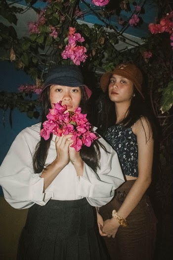 Two Women Standing Near Pink Bougainvillea Flowers