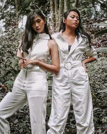 Two Women Standing Near Plants