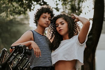 Two Women Standing Near Tree