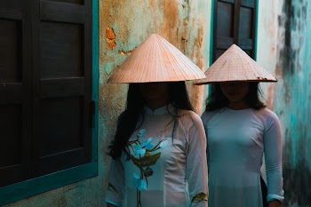 two women standing near window