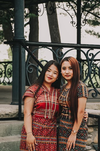 Two Women Standing Next to Each Other