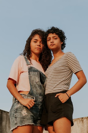 Two Women Standing Next to Each Other