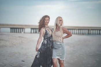 Two Women Standing Next to Each Other