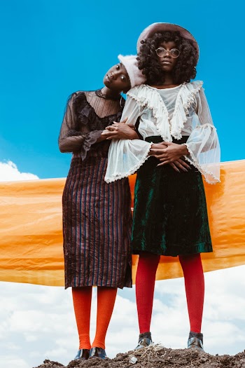 Two Women Standing on Hill