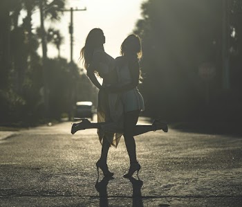 Two Women Standing on Road