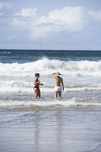 Two Women Standing On Shore